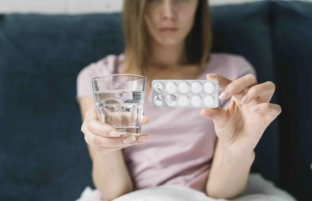 sick-woman-showing-pill-blister-pack-glass-water2
