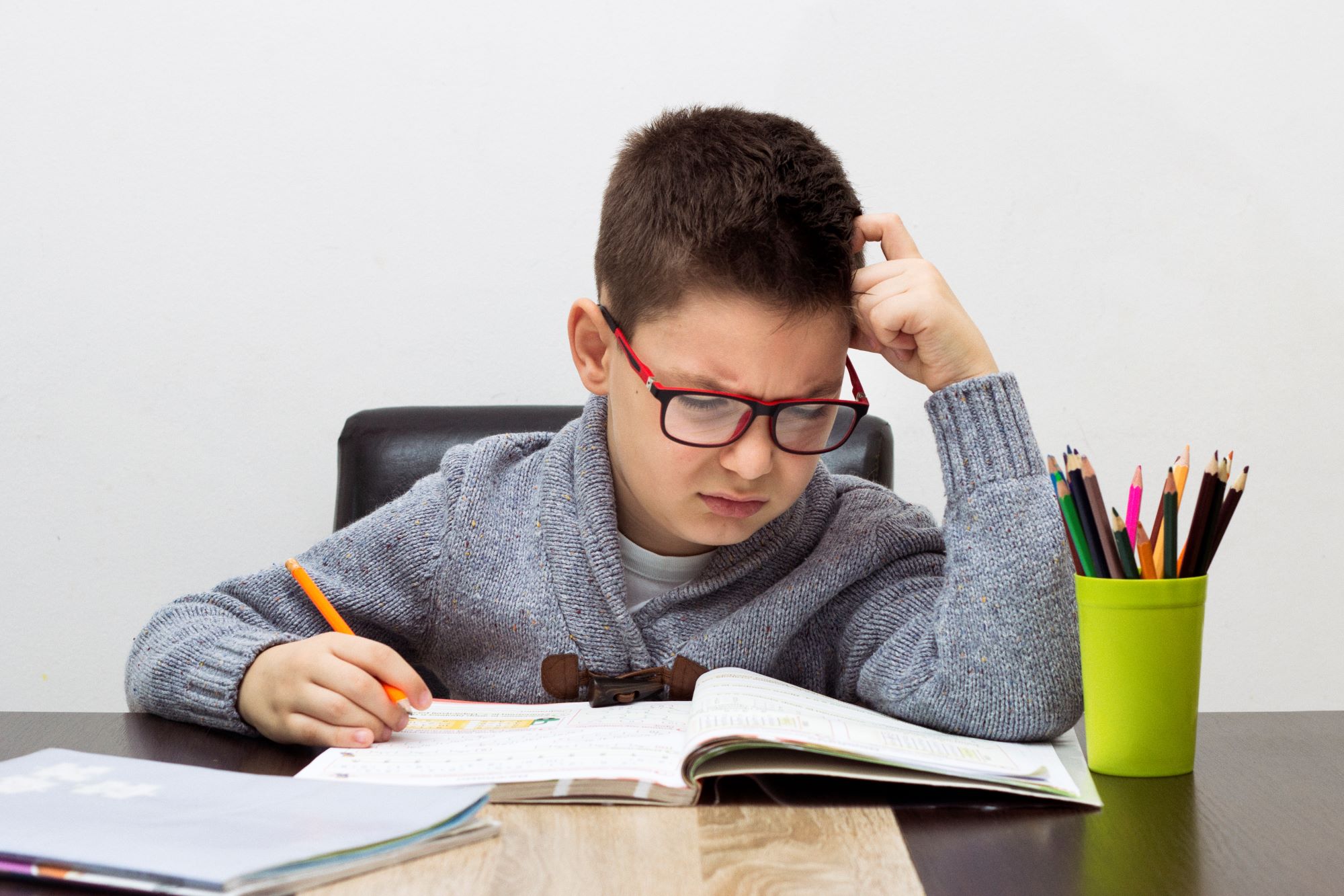 young-boy-frustrated-homework-writing-home-boy-studying-table-kid-drawing-with-pencil